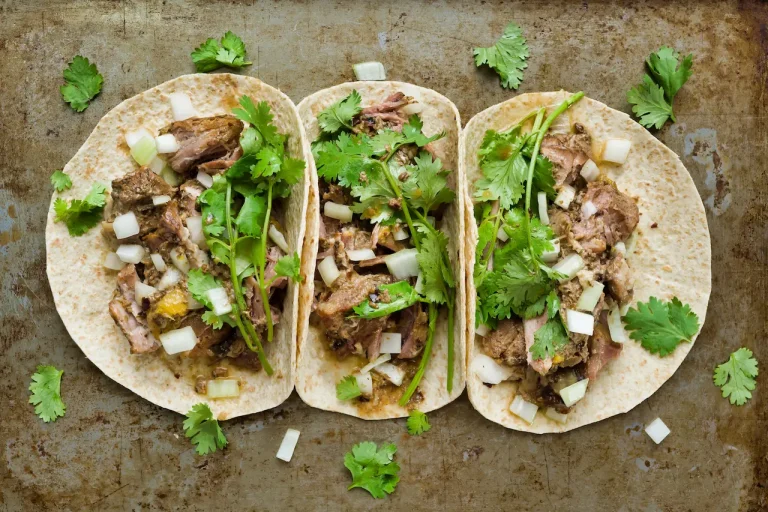 Three Pork Carnitas Taco With Green Leaves